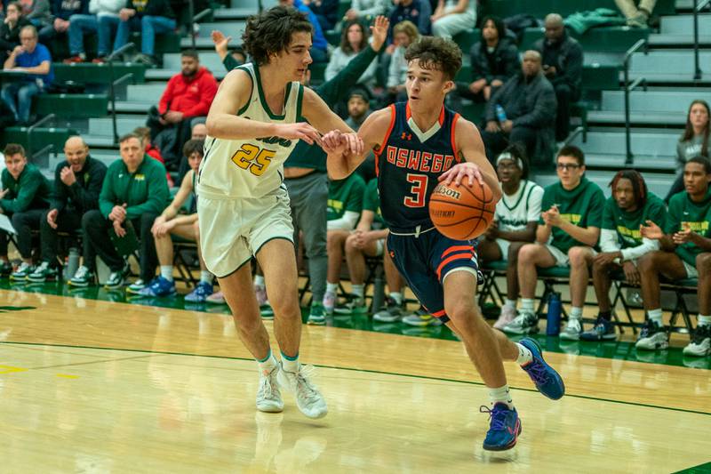 Oswego’s Max Niesman (3) drives the baseline against Waubonsie Valley's Jackson Langendorf (25) during a Waubonsie Valley 4A regional semifinal basketball game at Waubonsie Valley High School in St.Charles on Wednesday, Feb 22, 2023.