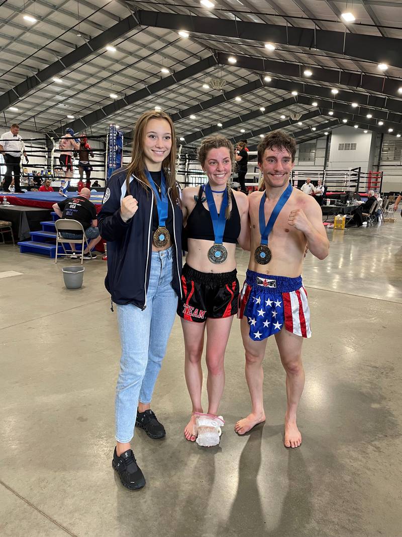 Cheyenne Welker, Meryl Swidler and Romeo Orosco pose after winning gold medals at the 2023 World Association Kickboxing Organizations (WAKO) USA National Championships held in Nashville in May.