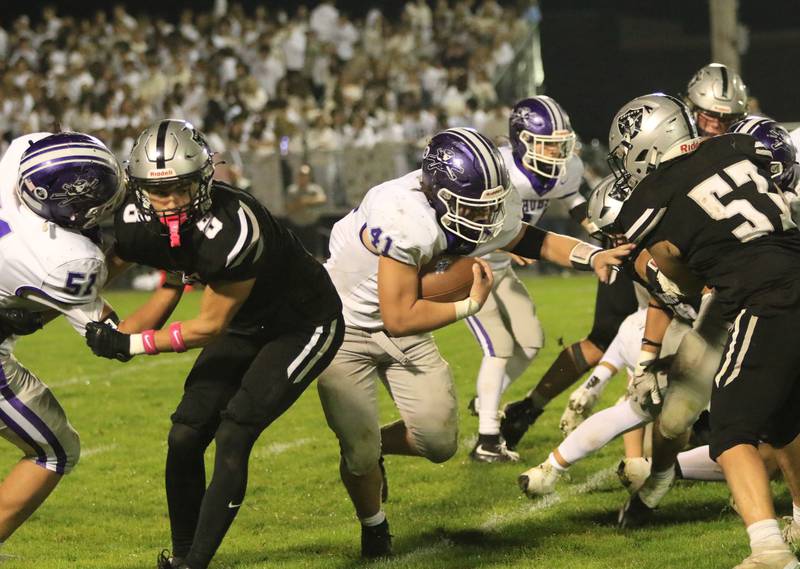 Rochelle's Tyler Gensler (41) runs through a hole during Friday's game at Kaneland.