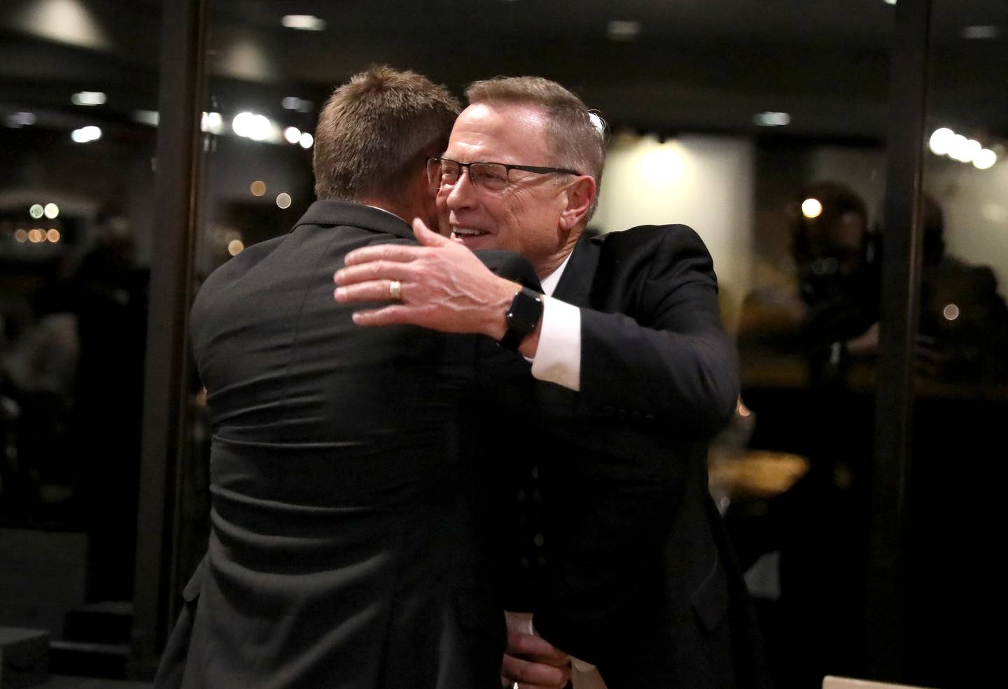 Chuck Howlett hugs his son, Charlie, after he and his wife, Heidi, were announced as the 2024 Geneva Chamber of Commerce Wood Award winners during the chamber’s annual dinner and awards ceremony on Thursday, Nov. 7, 2024 at Riverside Receptions in Geneva.