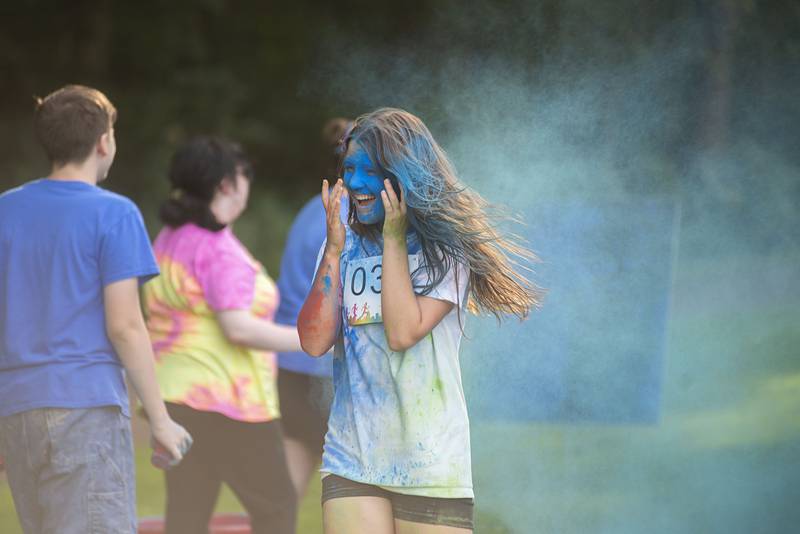 Bella Henson reacts to getting a face full of color Saturday, August 6, 2022 at Woodlawn.