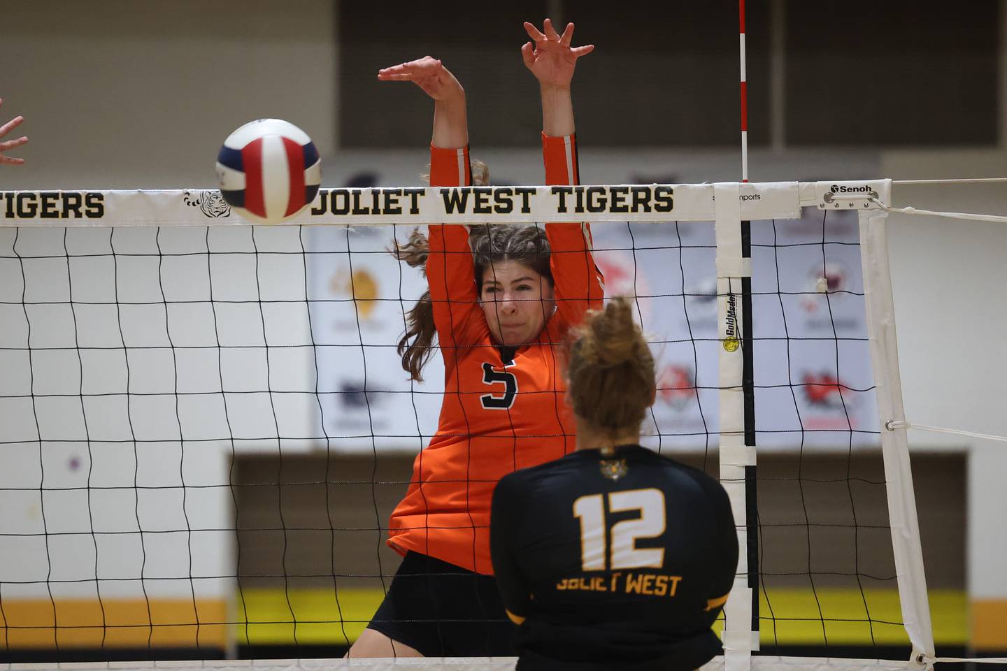 Lincoln-Way West’s Caroline Smith blocks a shot for the point against Joliet West on Tuesday, Sept. 12, in Joliet.