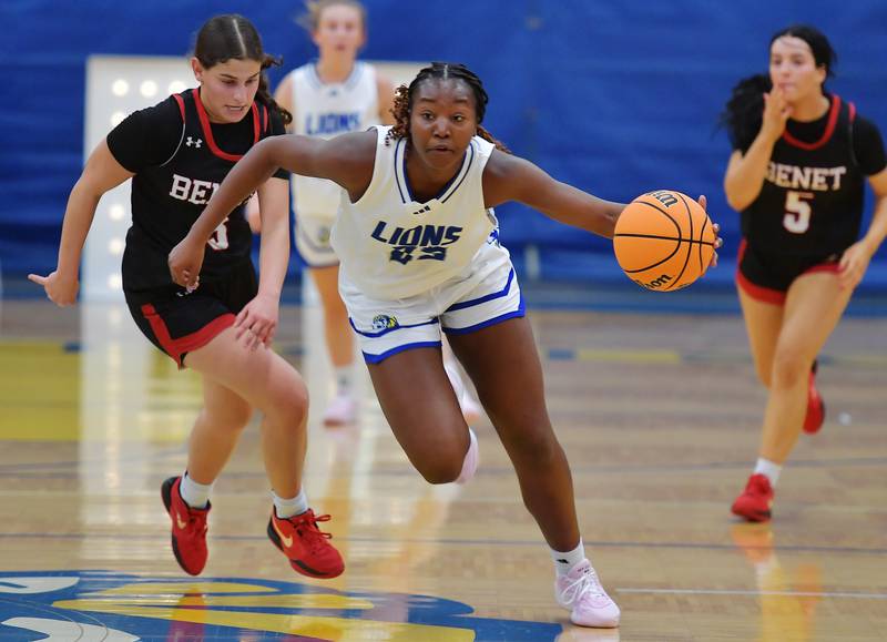 Lyons Township's Nora Ezike takes off with the ball after a steal as Benet's Aria Mazza (left) chases during a game on November 19, 2024 at Lyons Township High School in LaGrange.
