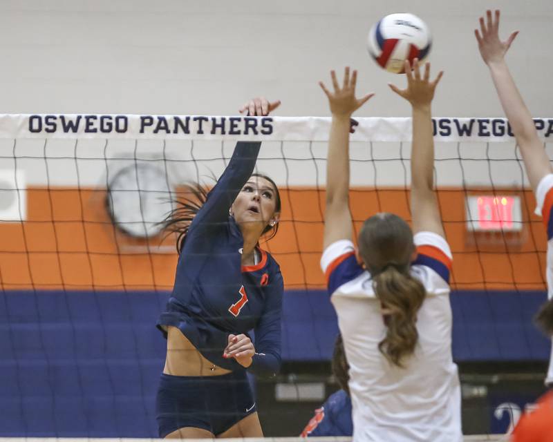 Oswego's Hannah Herrick (7) hits a kill during volleyball match between Romeoville at Oswego. Oct 16, 2025.