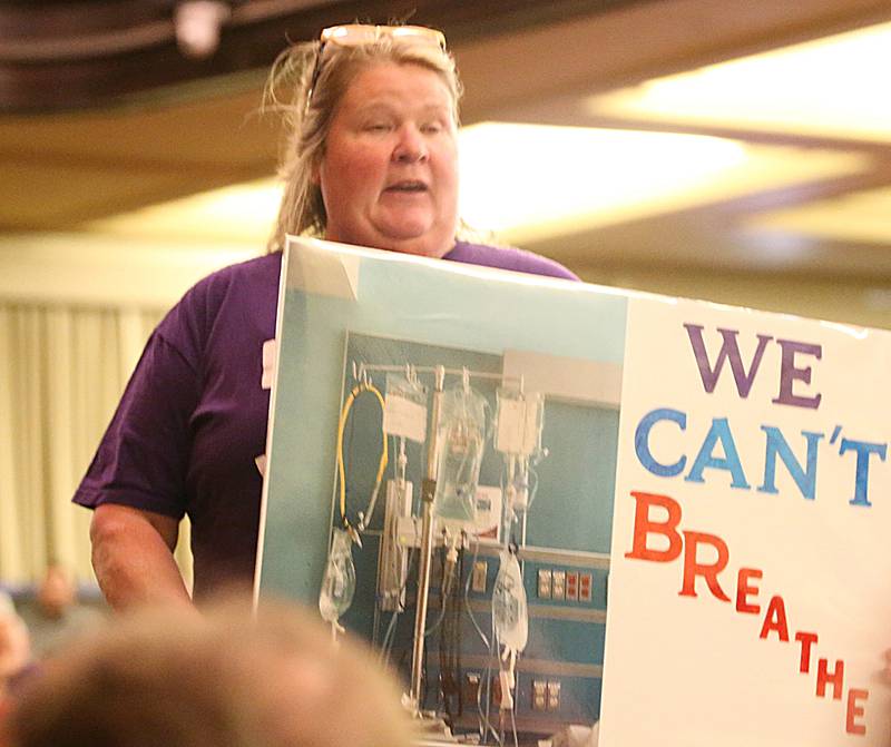 Lisa Hicks of La Salle, holds a sign saying "We Can't Breathe" during the Carus town hall meeting on Wednesday, May 10, 2023 in Matthiessen Auditorium at LaSalle-Peru Township High School. Her son has had lung health issues ever since the Jan. 11 fire.