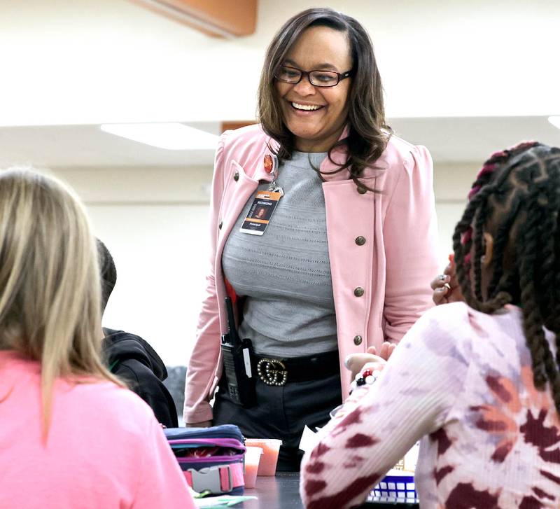Treveda Redmond, principal at Huntley Middle School, has a laugh with sixth-grade students during lunch Tuesday, March 14, 2023, at the school in DeKalb.