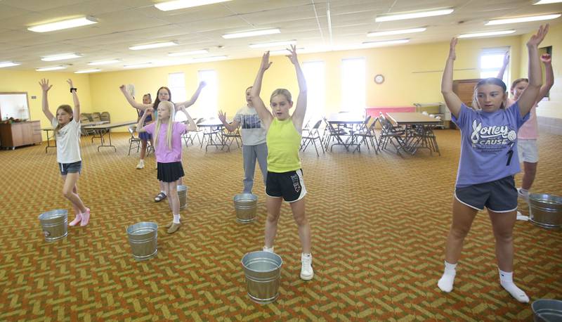 The cast of Annie Jr. rehearses for the upcoming musical on Tuesday, June 24, 2025 at the First United Methodist Church in Henry. The show will be presented July 25-27 at the River Valley Players theater in Henry, .