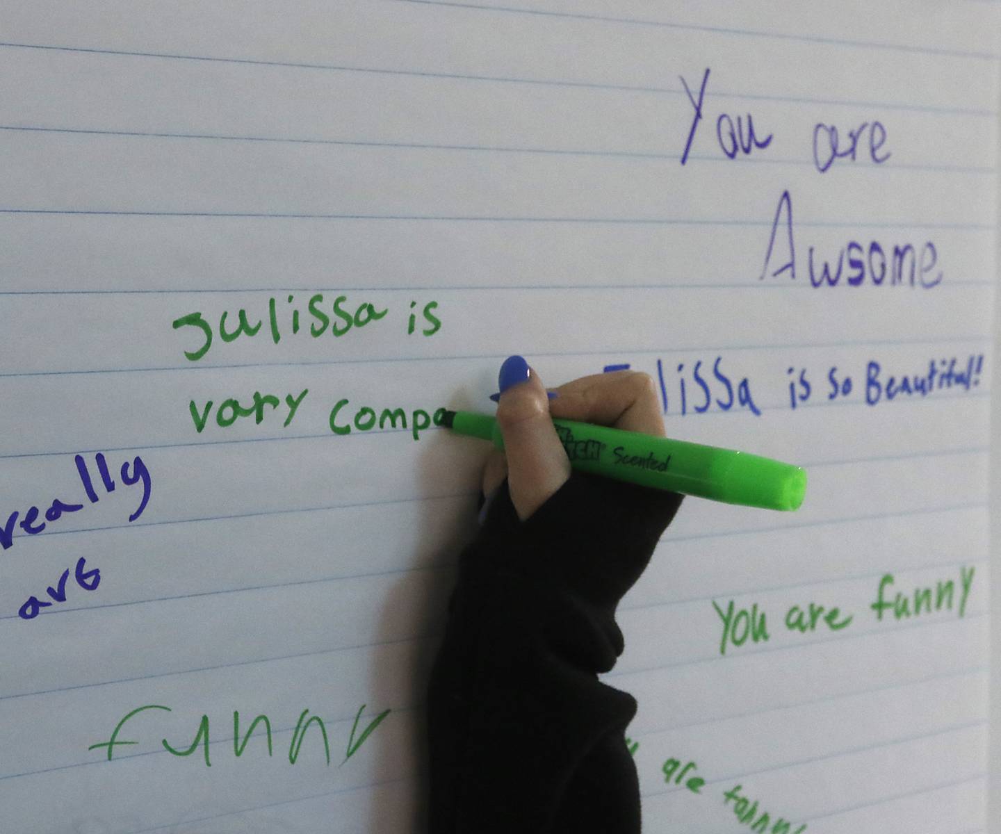 A fifth-grader writes a nice thing to a classmate on a pad of paper Tuesday, March 14, 2023,  during a lesson by social worker Jenn Sanchez and social-emotional learning coordinator Kristen Ziemba on kindness at South Elementary School in Crystal Lake.