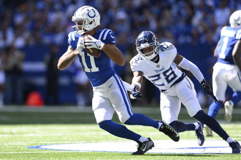 Indianapolis Colts wide receiver Michael Pittman Jr. (11) runs past Tennessee Titans defensive back Joshua Kalu (28) after a catch during an NFL football game, Sunday, Oct. 2, 2022, in Indianapolis. (AP Photo/Zach Bolinger)