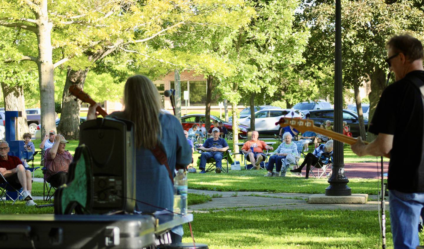 From the pavilion at John Dixon Park, the crowd gathered in lawn chairs arranged in a semicircle listens to Kathy Cecchetti and the Acoustic Circus on Friday during the opening night of the Music at the Square summer series.