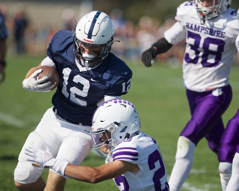 Cary Grove's Landon Barnett is run out of bounds by Hampshire's Jaxon Currie on Saturday Oct. 5,2024 in Cary.