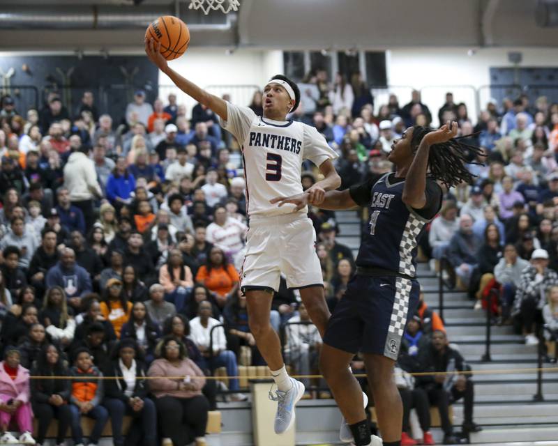 Oswego's Ethan Vahl (3) attempts a lay up during their basketball game between Oswego East at Oswego Friday, Jan 09, 2025 in Oswego.