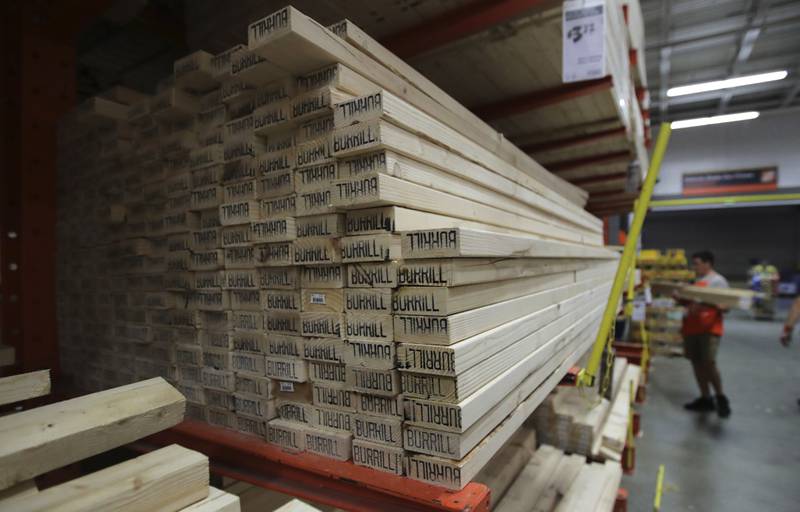 FILE - In this July 11, 2019, file photo lumber is stacked at the Home Depot store in Londonderry, N.H. Don’t let your desire to upgrade your home downgrade your home's market value. Before you make a renovation fantasy a reality, consider whether the project will pay off when you're ready to sell. (AP Photo/Charles Krupa, File)