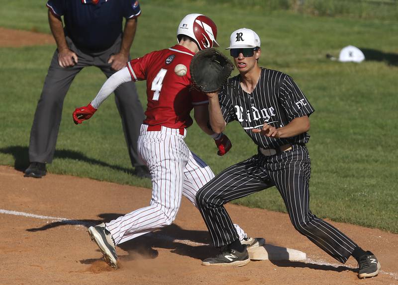 Deerfield's Sam Kanter beats the throw to Prairie Ridge's Karson Stiefer during a Class 3A Deerfield baseball regional game on Wednesday, May 22, 2024, at the Deerfield High School.