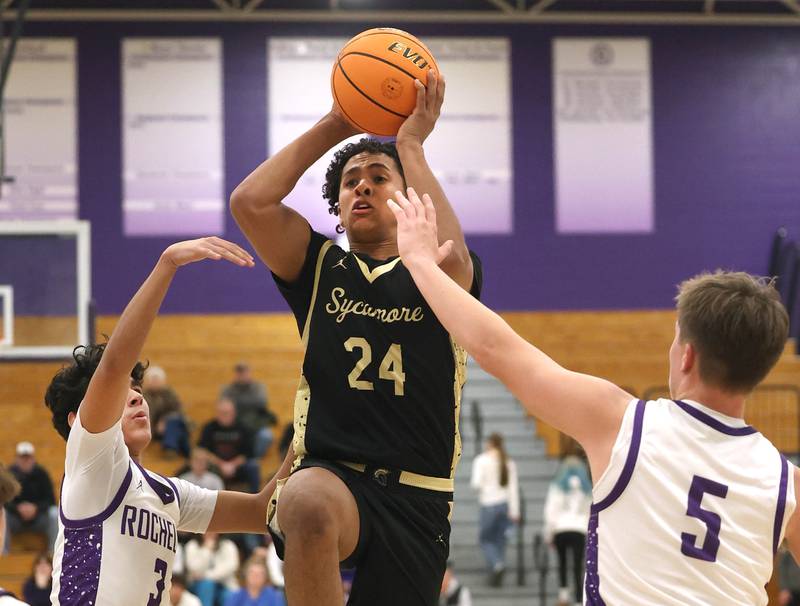 Sycamore's Tyler Townsend splits two Rochelle defenders Friday, Dec. 5, 2025, during their game at Rochelle High School.