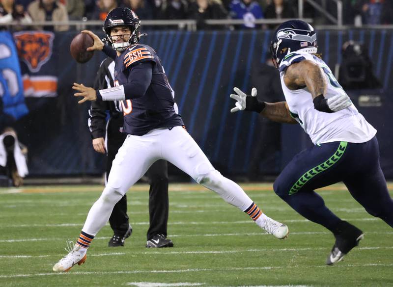 Chicago Bears quarterback Caleb Williams throws on the run as Seattle Seahawks defensive tackle Byron Murphy II applies the pressure during their game Sunday, Dec. 26, 2024, at Soldier Field in Chicago.