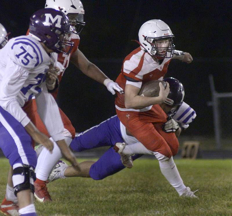 Streator’s Isaiah Weibel works to escape the pocket on a run in the 2nd quarter Friday at Streator.