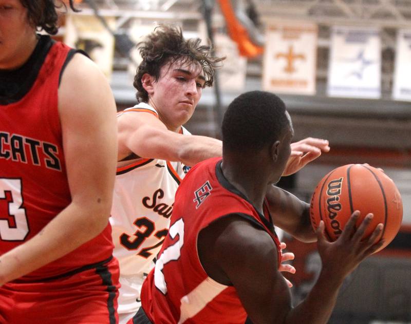St. Charles East’s Edward Herrera (32) goes after the ball held by East Aurora’s Ralph Clark during a game in the 63rd Annual Ron Johnson Thanksgiving Tournament at St. Charles East on Monday, Nov. 21, 2022.