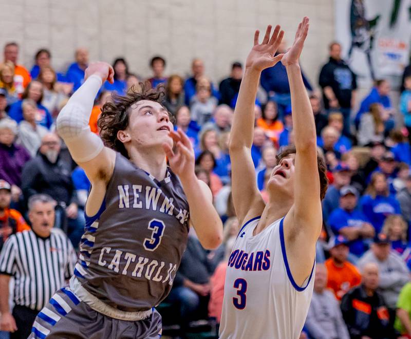 Newman's Garret Matznick puts up for a floater against Eastland's Tanner Stern during the first half of action at West Carroll on Friday, February 28, 2025.
