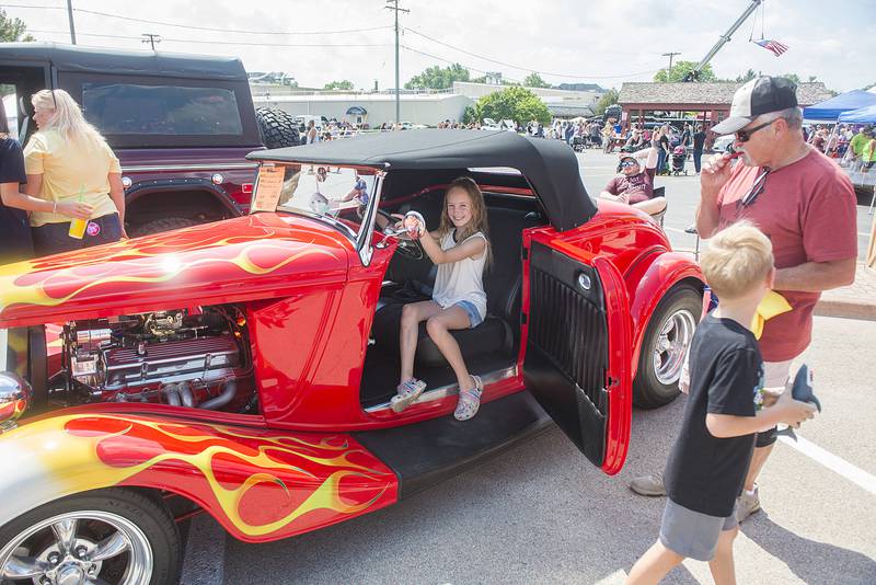 Lyla Stage, 9, of Rock Falls sits in the cockpit of Al Kammerer’s 1934 Ford Sunday, Aug. 28, 2022 during Amboy Depot Days’ car show.