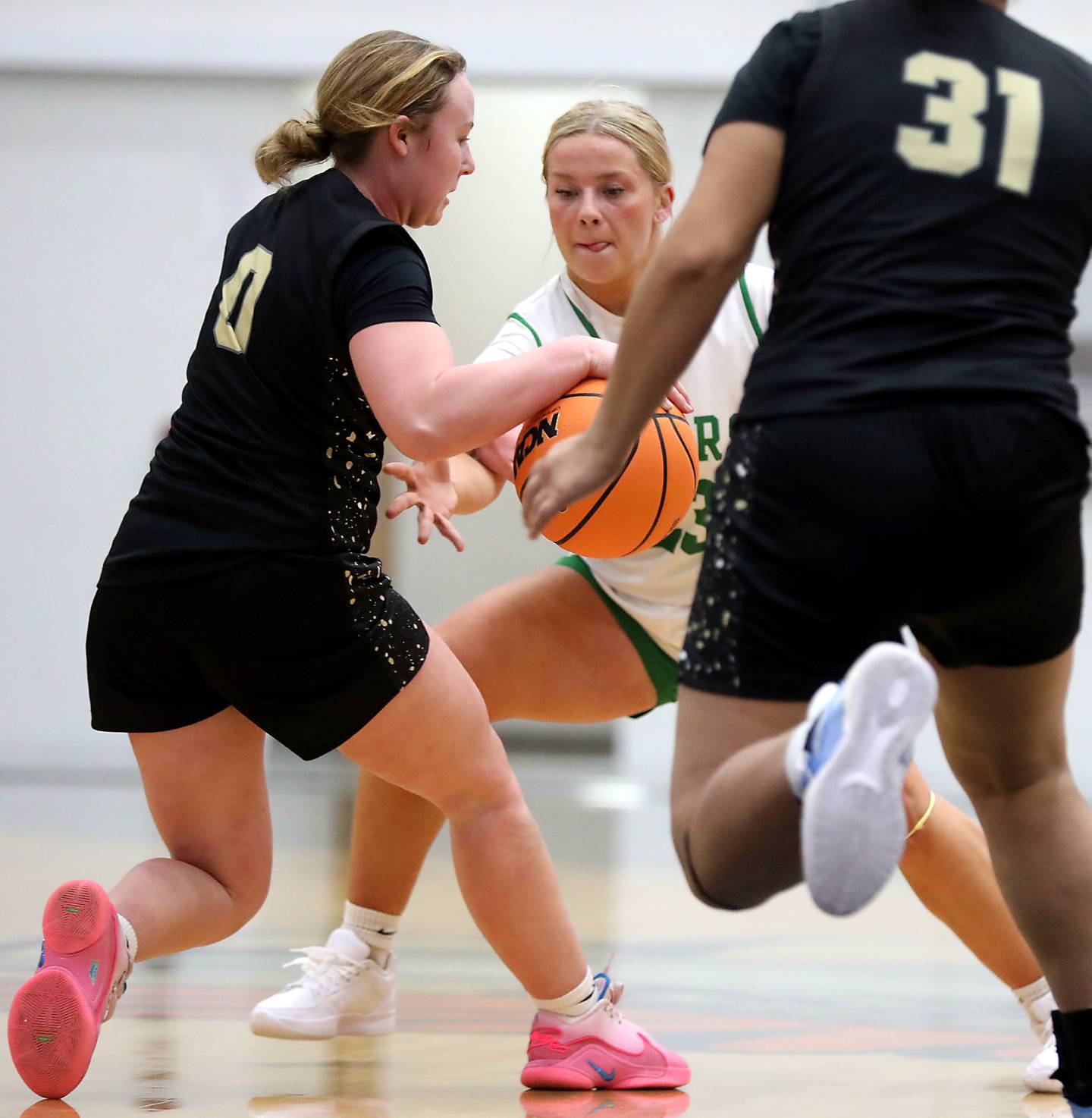 Crystal Lake South's Laken LePage tries to steal the ball from Grayslake North's Jane Pritchard during a Northern Illinois Holiday Classic semifinal girl basketball game on Tuesday, Dec. 16, 2025, at McHenry High School.