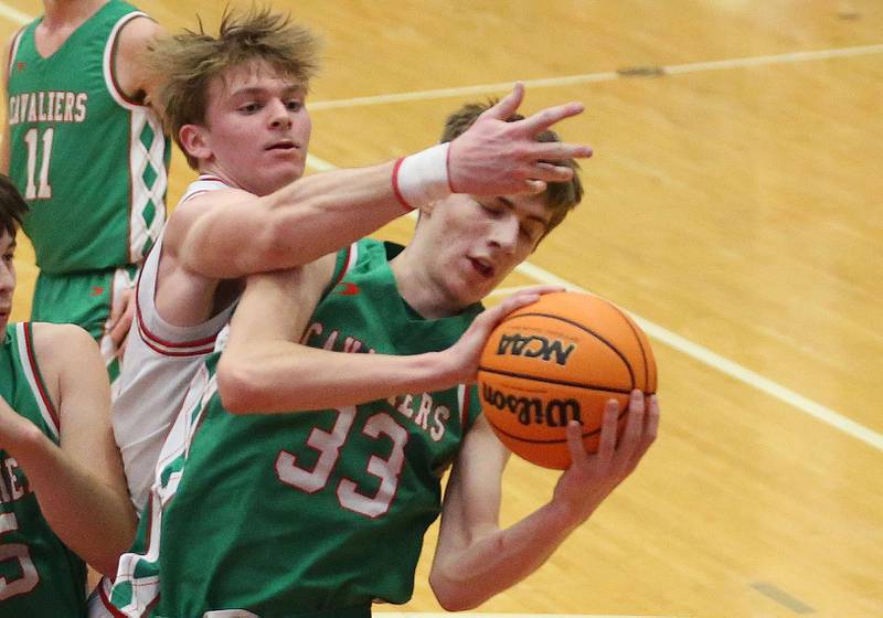 L-P's Gavin Stokes grabs a rebound over Ottawa's Owen Sanders on Friday, Feb. 6, 2026 in Kingman Gymnasium at Ottawa High School.