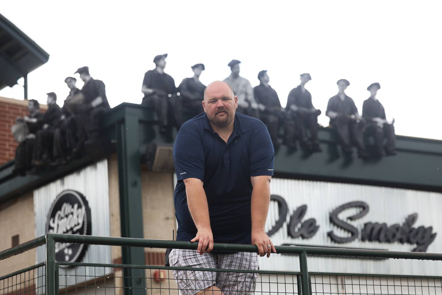 Joel Siegel poses in front of the iconic steelmen statue that has been restored and put above the Ole Smoky stand at Duly Health and Care Field as preperations are made for the Joliet Slammers’ opening day on Friday.