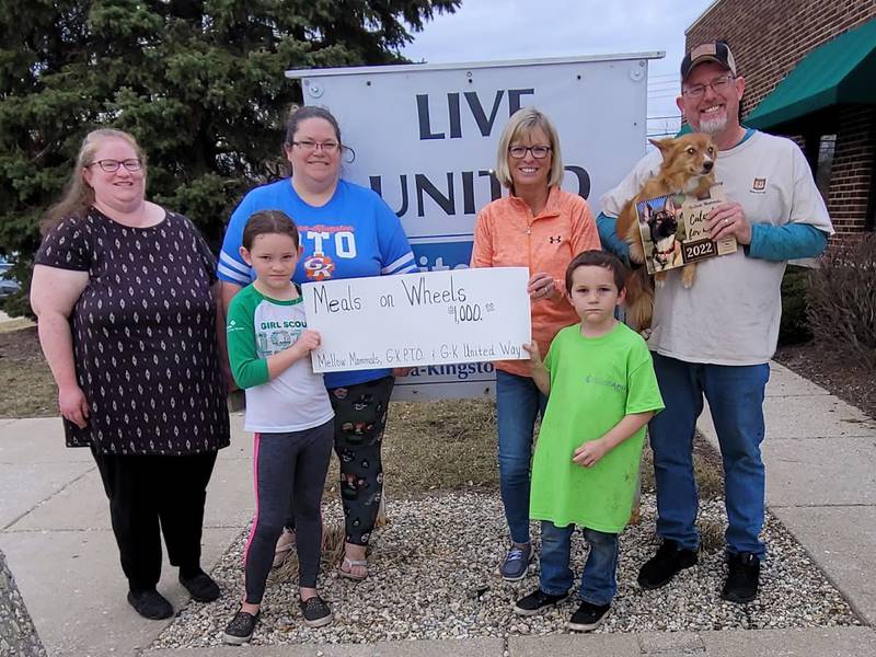 Leah Jordal from Meals on Wheels receives $1,000 donation from Pattie Klassen from G-K PTO, Marcy Billington from G-K United Way, and Garrick Cline from Mellow Mammals.