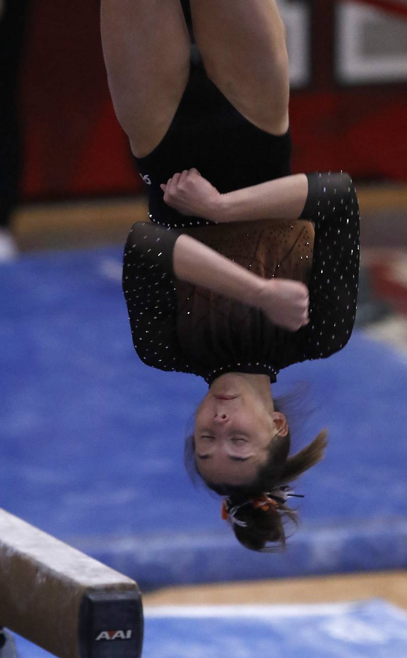 Libertyville’s Anna Baker competes in the preliminary round of the balance beam Friday, Feb. 17, 2023, during the IHSA Girls State Final Gymnastics Meet at Palatine High School.