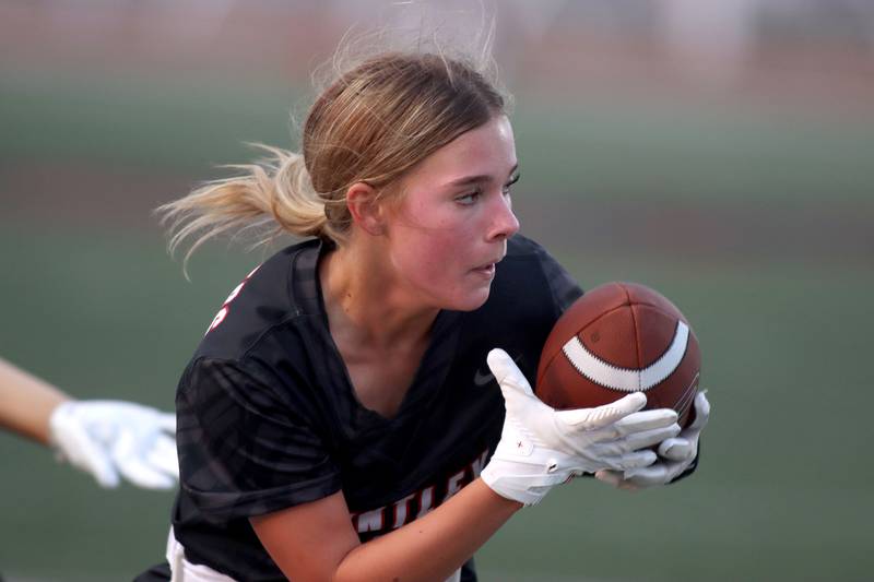 Huntley’s Addison Avi carries the ball against McHenry in varsity flag football at Huntley High School in Huntley on Tuesday, Sept. 9, 2025.