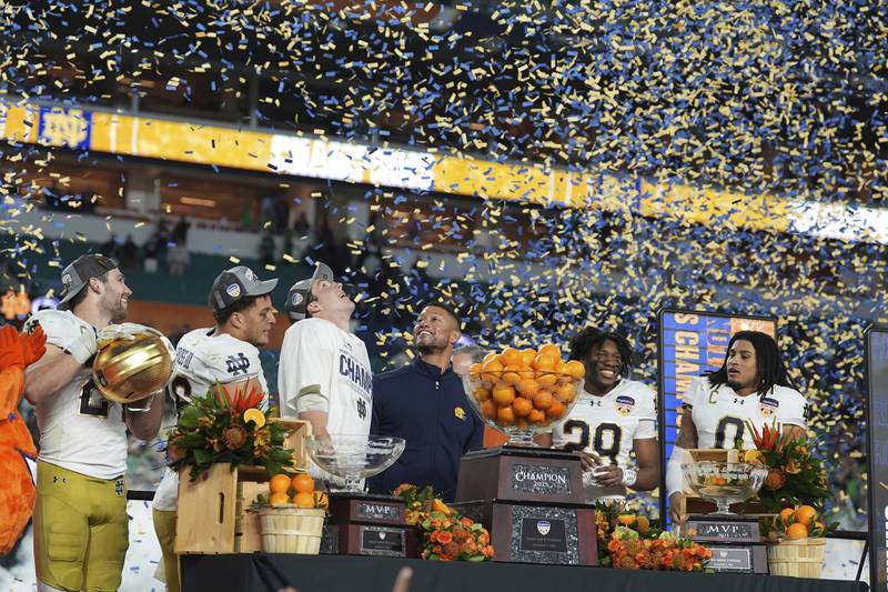 Notre Dame head coach Marcus Freeman, center, and members of the team celebrate after winning the Orange Bowl College Football Playoff semifinal game against Penn State, Thursday, Jan. 9, 2025, in Miami Gardens, Fla. (AP Photo/Rebecca Blackwell)