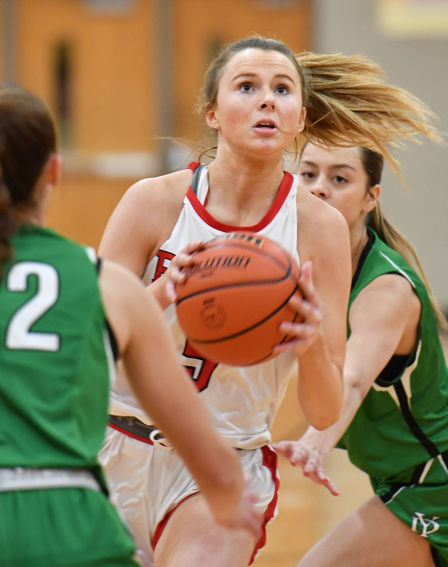 Benet's Lenee Beaumont goes to the hoop between two York defenders during a game on Dec. 20, 2022 at Benet Academy in Lisle.