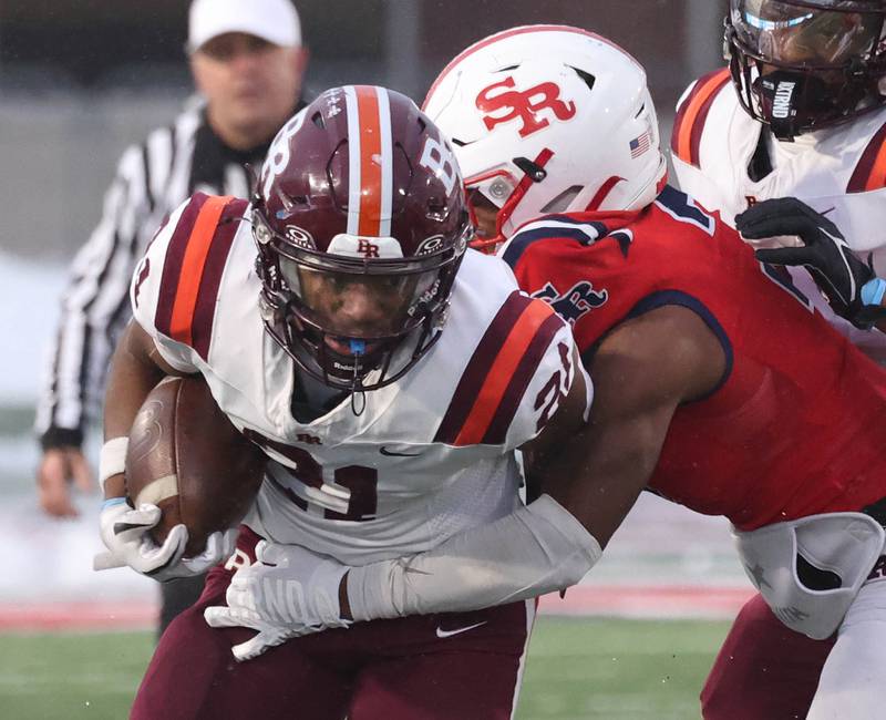 St. Rita's Tim Swanson tries to pull away from St. Rita's Langston Smith Wednesday, Dec. 3, 2025, during their IHSA Class 7A state chamionship game in Huskie Stadium at Northern Illinois University in DeKalb.