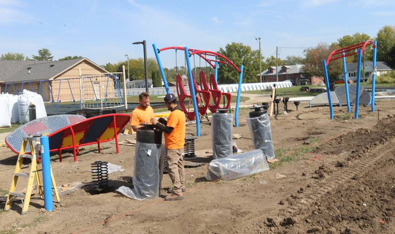 Crews from Build LLC Custom Playgrounds construct a ninja obstacle course located south of the splash pad on Thursday, Oct. 2, 2025 in Washington Park in Peru. The city will also be installing ice rink chillers soon for the upcoming winter season.