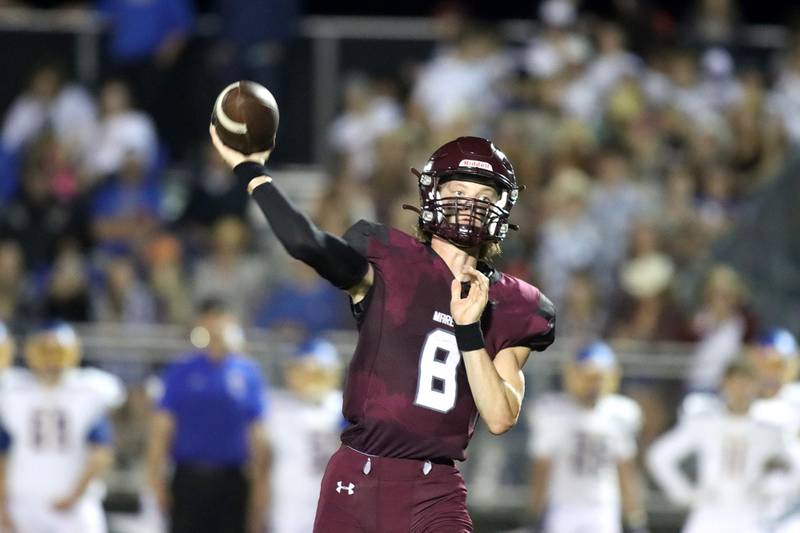 Marengo quarterback Joshua Holst tosses the ball against Johnsburg during football Friday night in Marengo.
