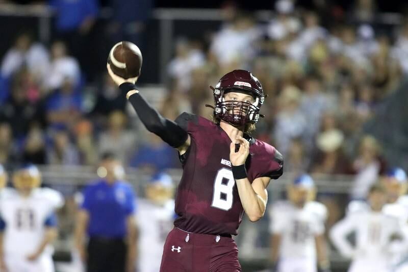 Marengo quarterback Joshua Holst tosses the ball against Johnsburg during football Friday night in Marengo.