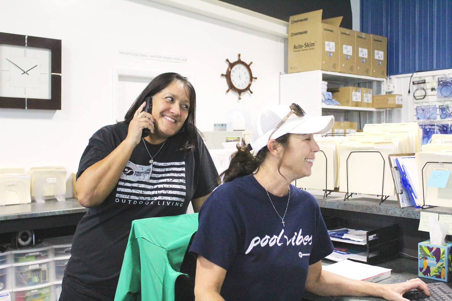 Angie Winchell (left) helps Poolside Pools and Spas co-owner Cary McCue with a service call at the Sterling store.