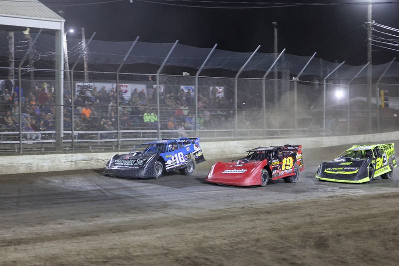 Austin McCarty, left, accelerates past the grandstands on Friday, Sept. 26, 2025, at the Kankakee County Speedway. McCarty won the Pro Late Model title for the second year in a row, earning the McCarty family's 10th overall title.