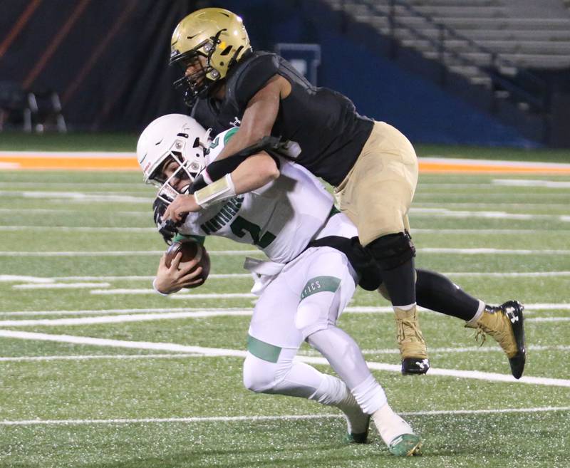 Providence Catholic quarterback Lucas Proudfoot is sacked by Sacred Heart-Grifin's Reggie Thomas in the Class 4A state title on Friday, Nov. 25, 2022 at Memorial Stadium in Champaign.