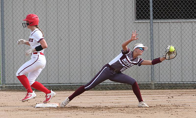 Ottawa's Hailey Larsen is safe at first base as Morris's Natalie Lawton catches the throw on Monday, May 15, 2023 at Ottawa High School.