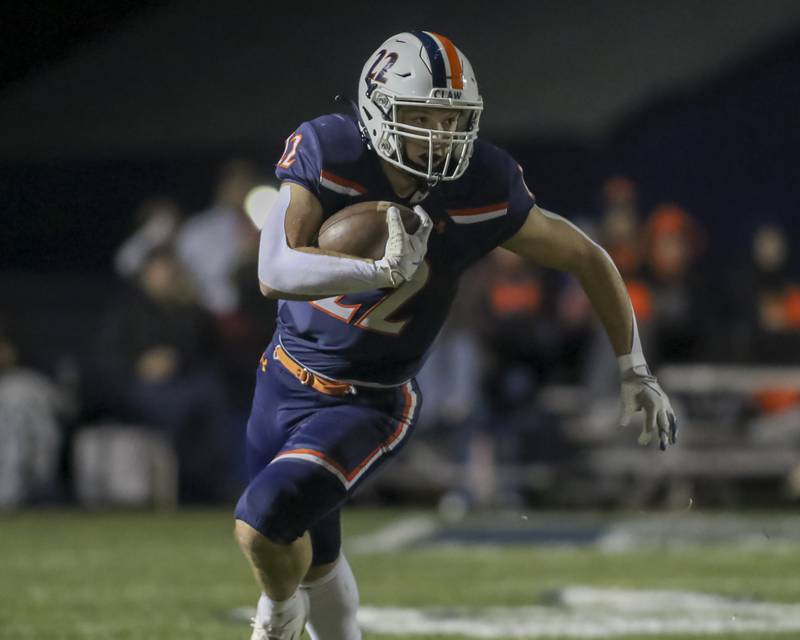 Oswego's Graham Schwab (22) takes off after a catching an outlet pass during Class 8A semifinal football game between Lockport at Oswego. Saturday, Nov 22, 2025 in Oswego.