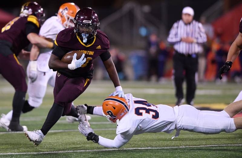 Montini's Isaac Alexander, left, makes a move past Rochester's Macklin Nelson during the IHSA Class 4A state championship game on Friday, Nov. 28, 2025 in Normal.