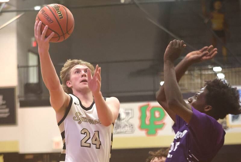 Sycamore's Lucas Winburn gets up a shot over Plano's Christ Keleba Tuesday, Jan. 3, 2023, during their game at Sycamore High School.