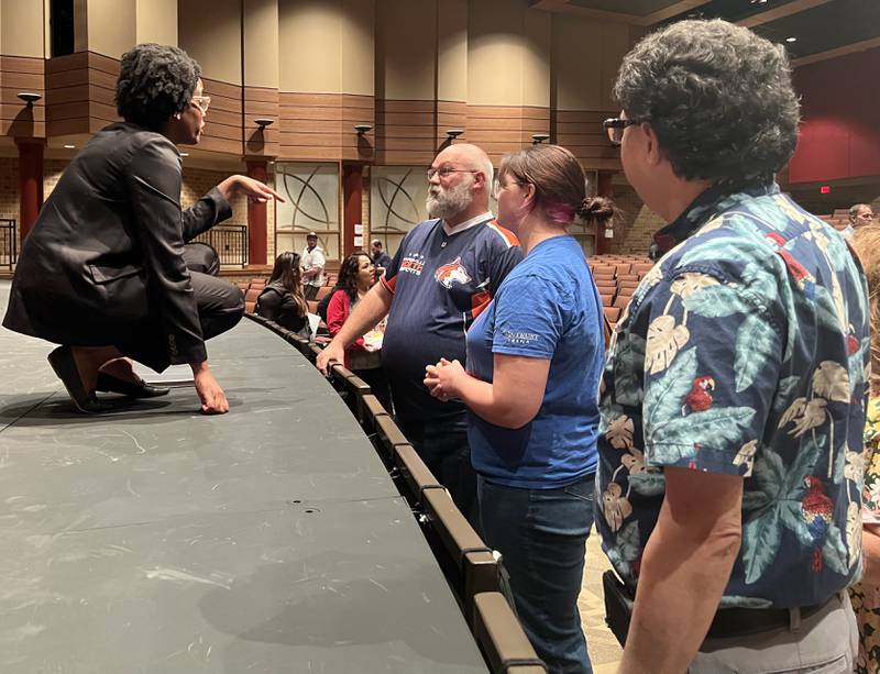 Kevin Gordon, right, waits to speak with Congress woman Lauren Underwood, D–Sandwich, after she talks with John and Erika Cole on Aug. 3, 2023.