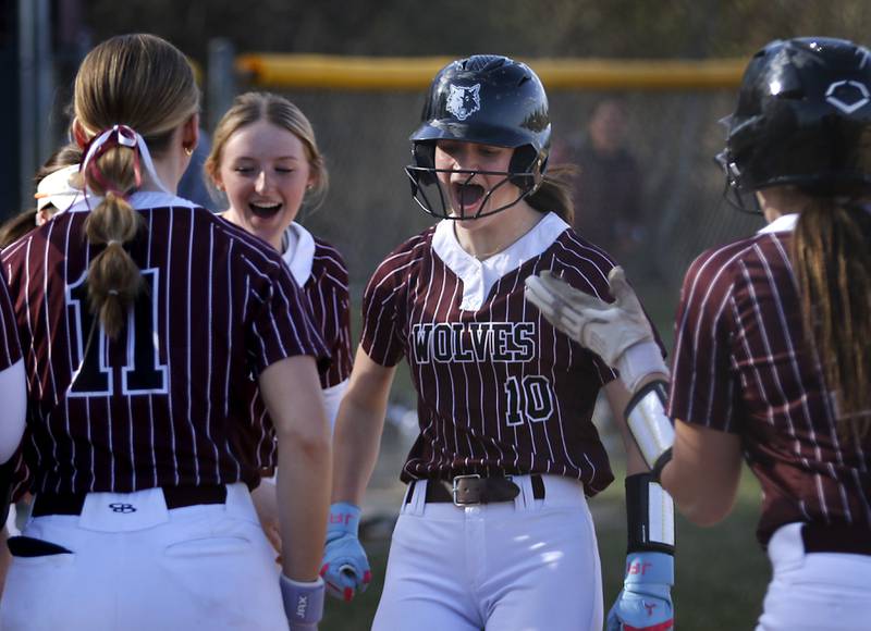 Prairie Ridge's Kylie Carroll celebrates her two-run homer with her teammates during Fox Valley Conference softball game against Huntley on Monday, April 14, 2025, at Prairie Ridge High School in Crystal Lake.