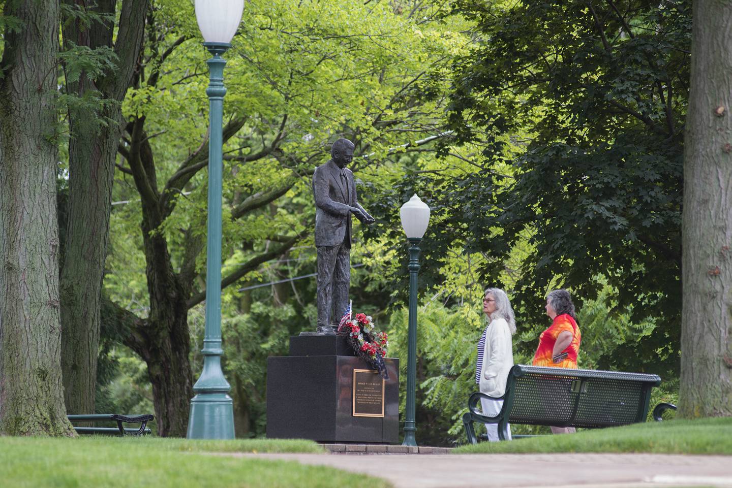 Visitors to the Reagan Boyhood Home in Dixon stop to check out the statue Thursday, July 15, 2021. The home has undergone a bit of a revival since taken over by the Young America’s Foundation earlier this year.