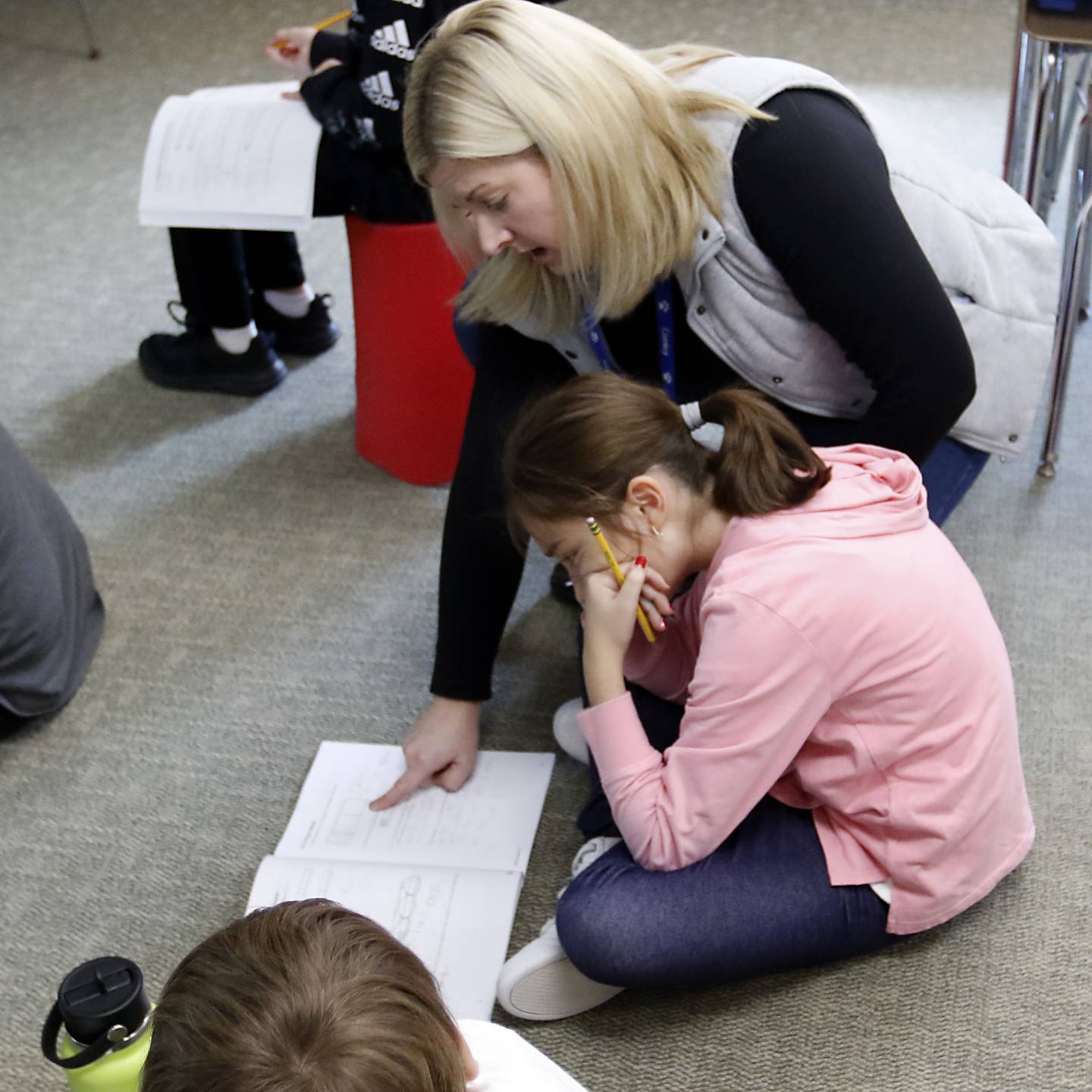 Fifth-grade teacher Jennifer Hollabaugh works with Eliona Ahmedi as she explains how to solve a math problem Wednesday, Oct, 26, 2022, to the students that Hollabaugh and Jim Garvalia co-teach at Conley Elementary School, 750 Dr. John Burkey Drive in Algonquin.