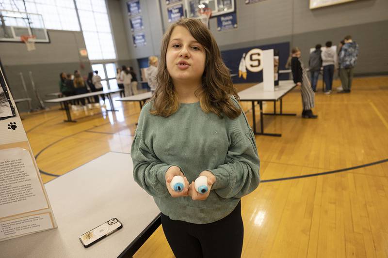 Sixth grader Ava Warren built model eyes to show the the difference between feline and human sight during a STEM exhibit at Challand Middle School Thursday, March 9, 2023. Cats have a special membrane that helps them see better in the dark, but are also mid-sighted that prevents them from seeing well far way and up close.