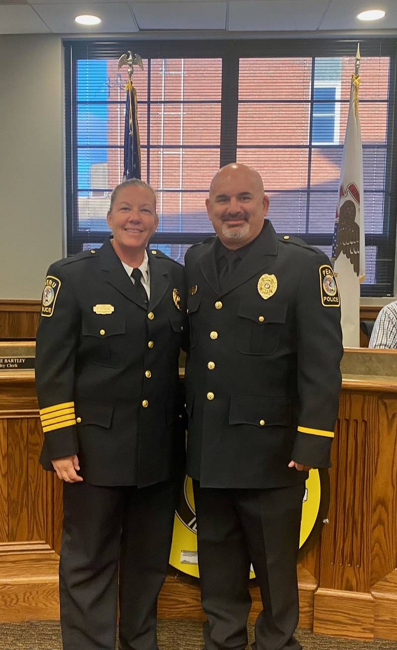 Peru Police Chief Sarah Raymond stands with newly promoted Sgt.Brad Jones during Monday nights city council meeting.