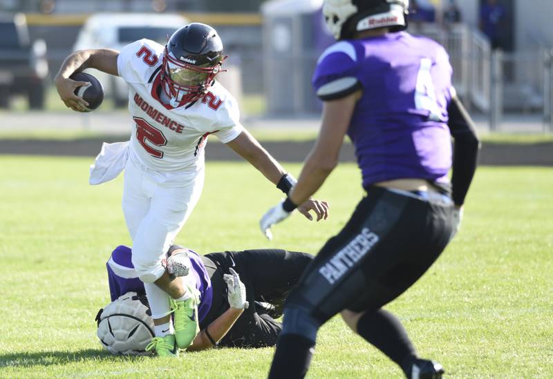 Momence's Erick Castillo evades a tackle as he carries the ball in a scrimmage game against Manteno on Friday, August 22, 2025.